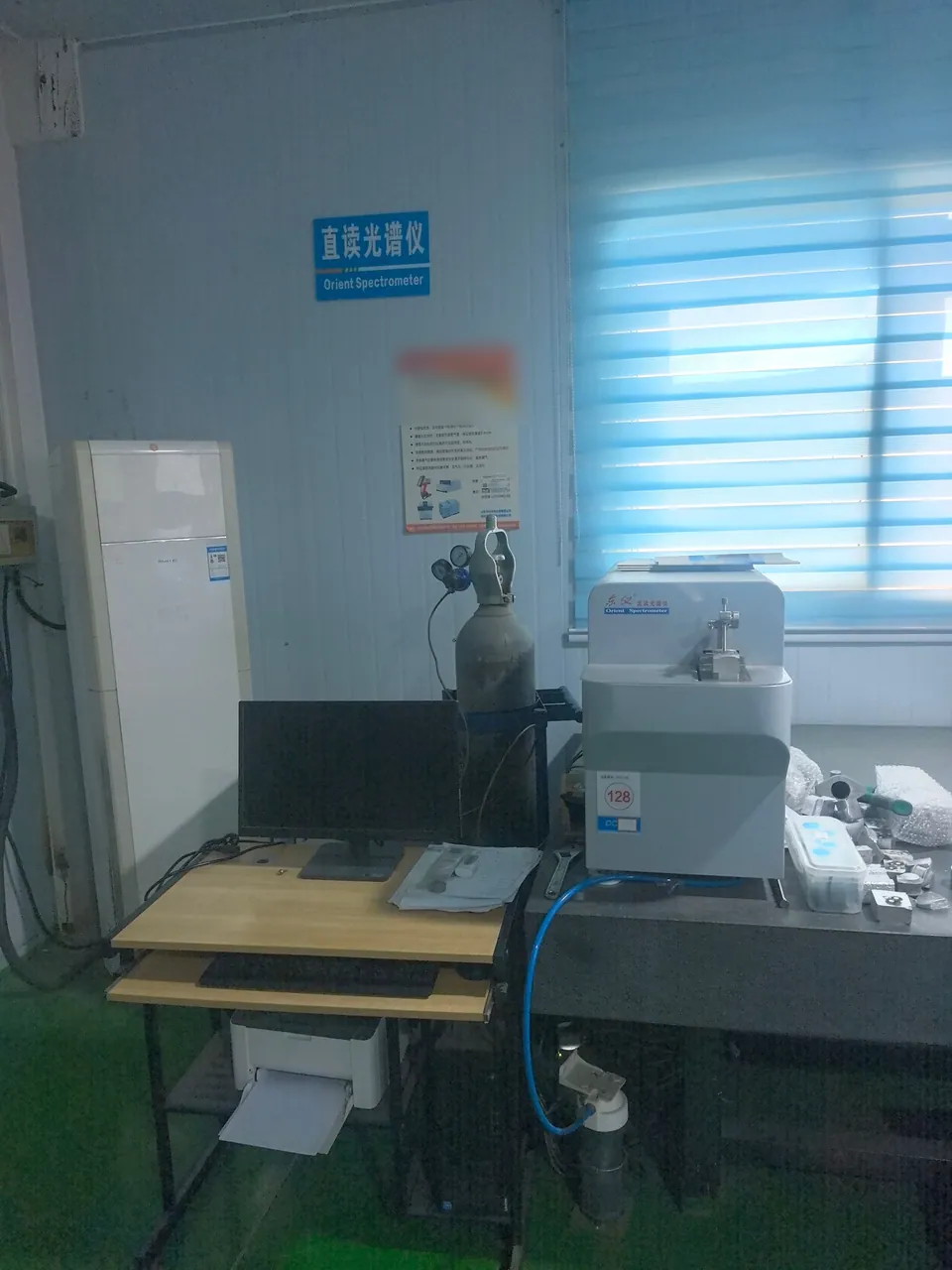 A direct-reading spectrometer workstation and gas cylinder in the inspection room