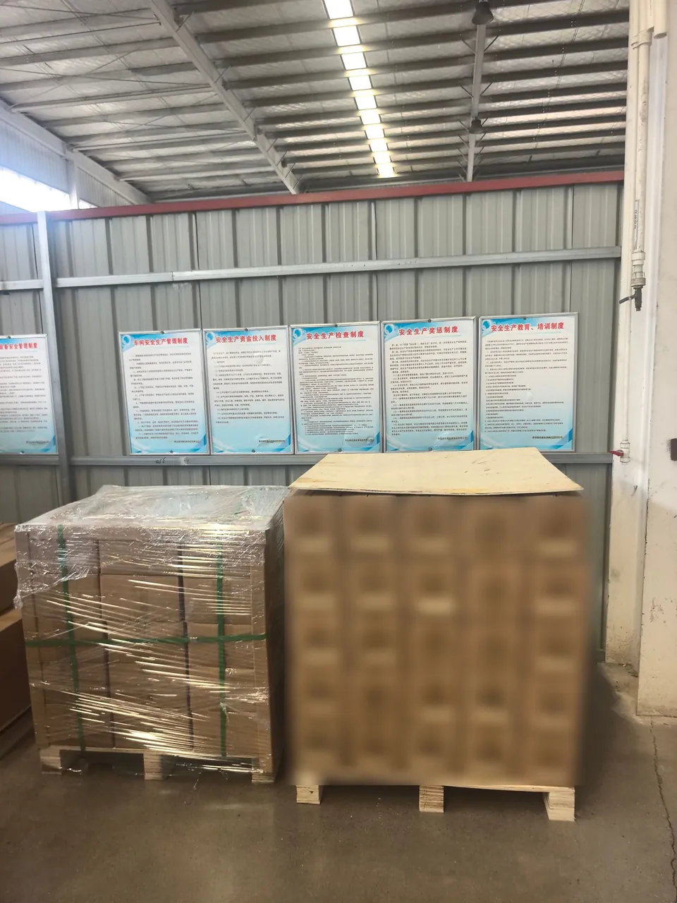 Cartons with batch labels beside a wrapped pallet