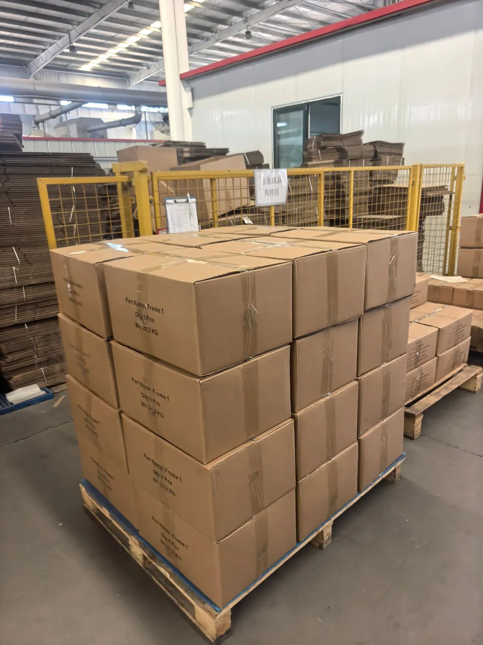 Stacked cartons on a wooden pallet beside packing materials