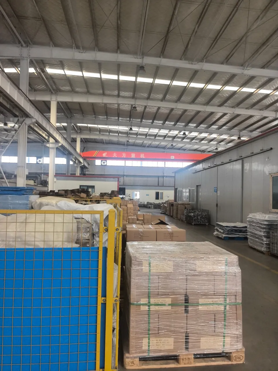 Palletized cartons and handling areas inside the workshop